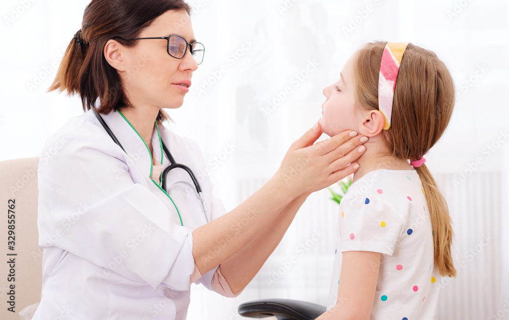 Doctor-physician checking pretty little girls glands Doctor-physician checking pretty little girls glands