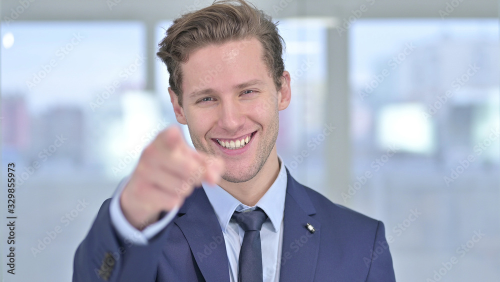 Portrait of Young Businessman Pointing Finger at Camera Portrait of Young Businessman Pointing Finger at Camera