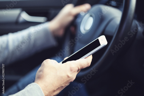 Man using mobile phone while driving car