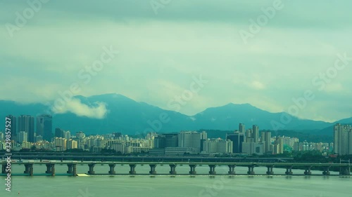 Time lapse shot of Seoul cityscape with Han River and traffic on bridges, South Korea photo