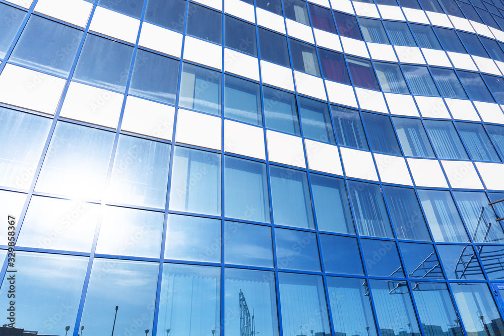 Reflection of the sun and city building silhouettes in the glass of an office building Reflection of the sun and city building silhouettes in the glass of an office building