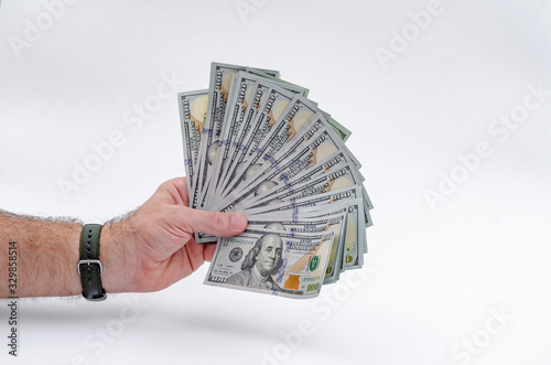 Male hand holds lot of paper american dollars