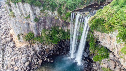 Aerial View of The High Waterfall Jeongbang and Lagoon on Jeju Island photo