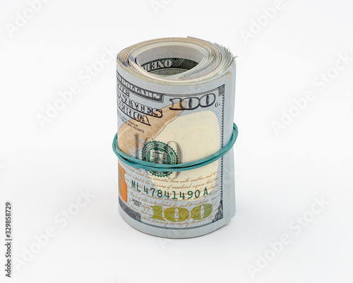 Stack of American dollars tied with rubber band for money