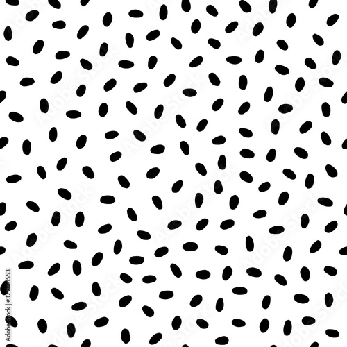 Seamless pattern. Black oval spots in a chaotic manner isolated on white background. Art texture. Texture for print, wallpaper, home decor, textile, package design, invitation or website background.