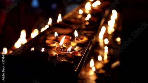 Candles close-up in the Indian Temple on a Religious Festival Diwali. Oil Lamp photo
