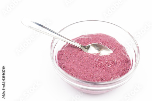 Smoothie made of blackberries in the bowl with spoon