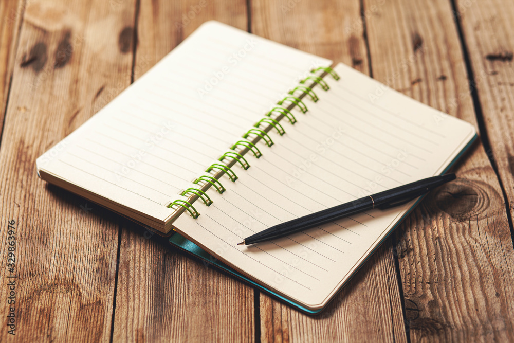 pen on notepad on the desk pen on notepad on the desk
