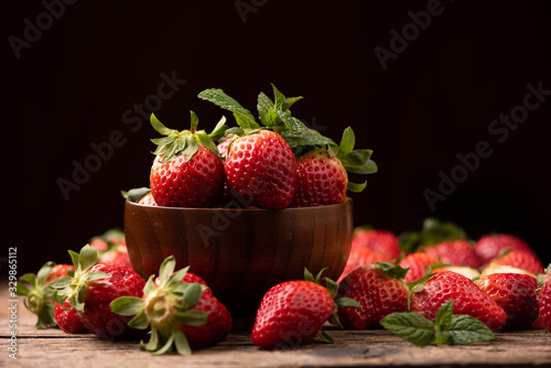 Fresh strawberry in basket on wooden rustic table