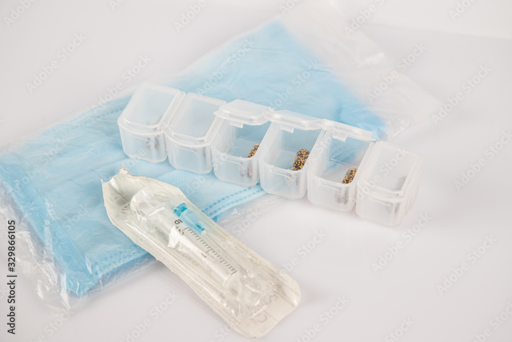 medical mask, syringes and pills on a white background. treatment of the disease and the virus. coronavirus medical mask, syringes and pills on a white background. treatment of the disease and the virus. coronavirus