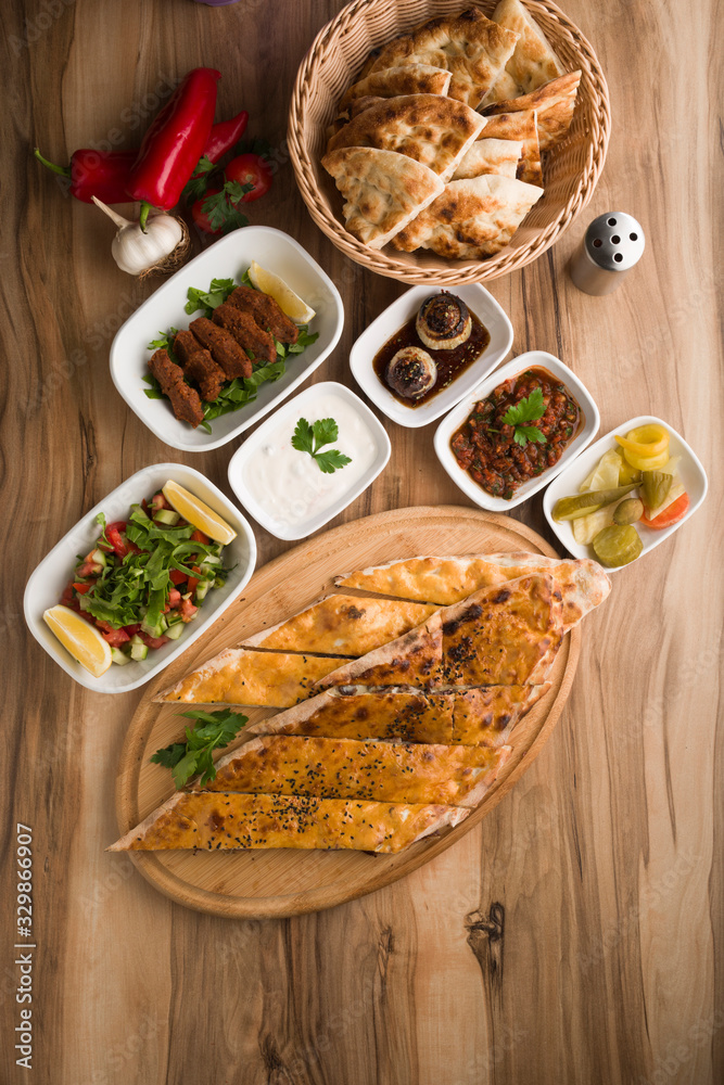 closed mince turkish pide on wooden table closed mince turkish pide on wooden table