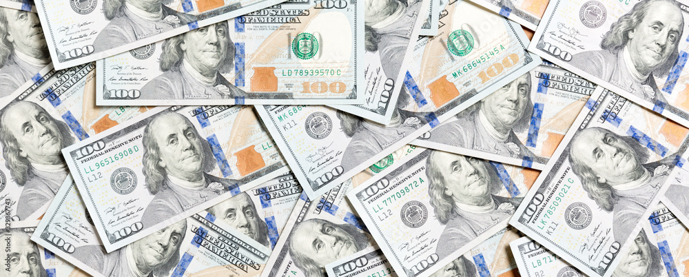 Top view of one hundred dollar banknotes made as a background. USD currency concept. Texture of American dollars Top view of one hundred dollar banknotes made as a background. USD currency concept. Texture of American dollars