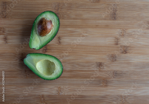  Sliced avocado on wooden table, high resolution photo