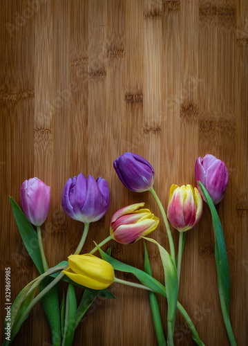 Wilted flowers tulips on wooden table, high resolution photo