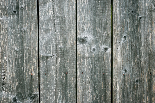 Old gray wooden floor, texture of boards, vertical lines on grunge wood fence. Hardwood carpentry.