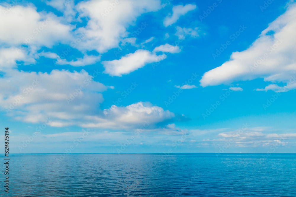 blue sea horizon and sky with clouds