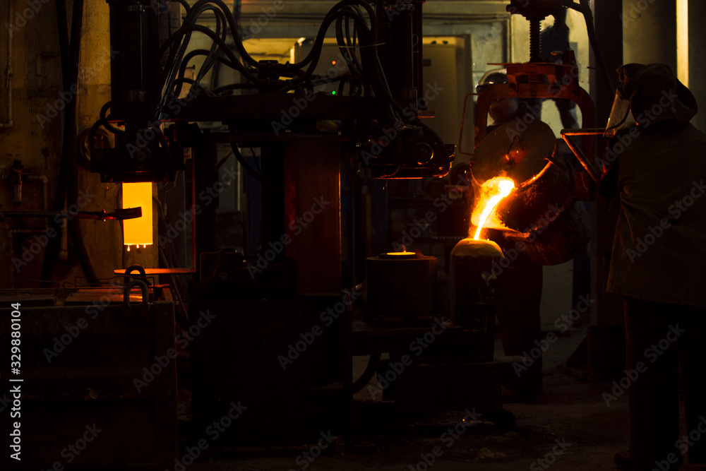 The molten liquid metal is poured into the mold.