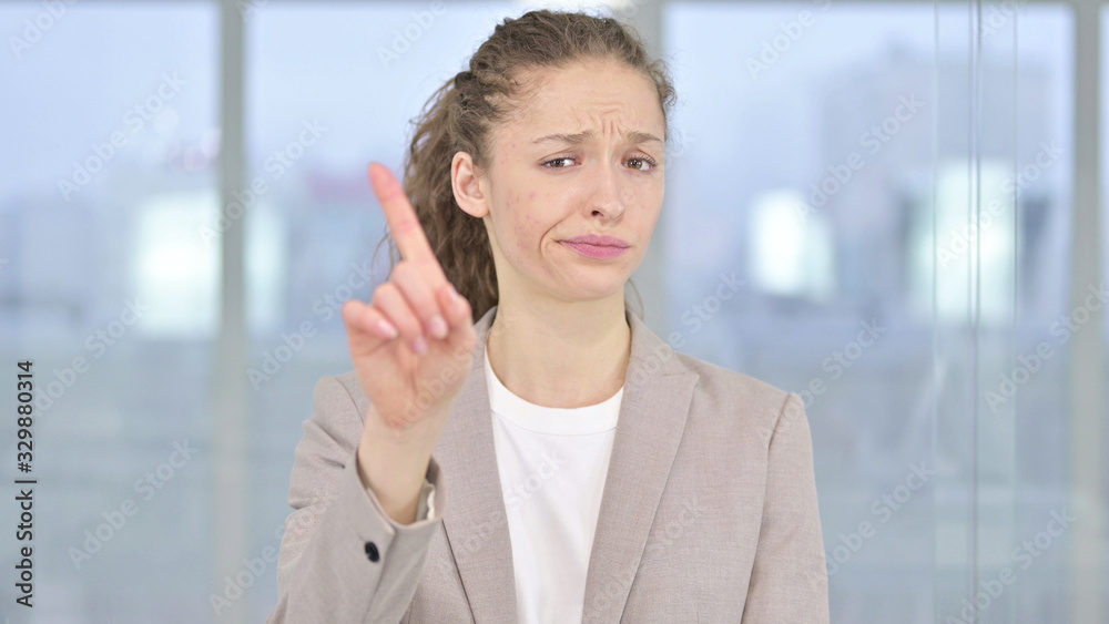 Portrait of Young Businesswoman saying No by Finger