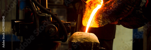 The molten liquid metal is poured into the mold.