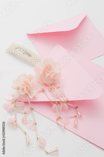 Wedding background, white with space for text, decorated with pink invitations, pearl jewelry, with copy space. Concept wedding flatly. © Карина Желнина