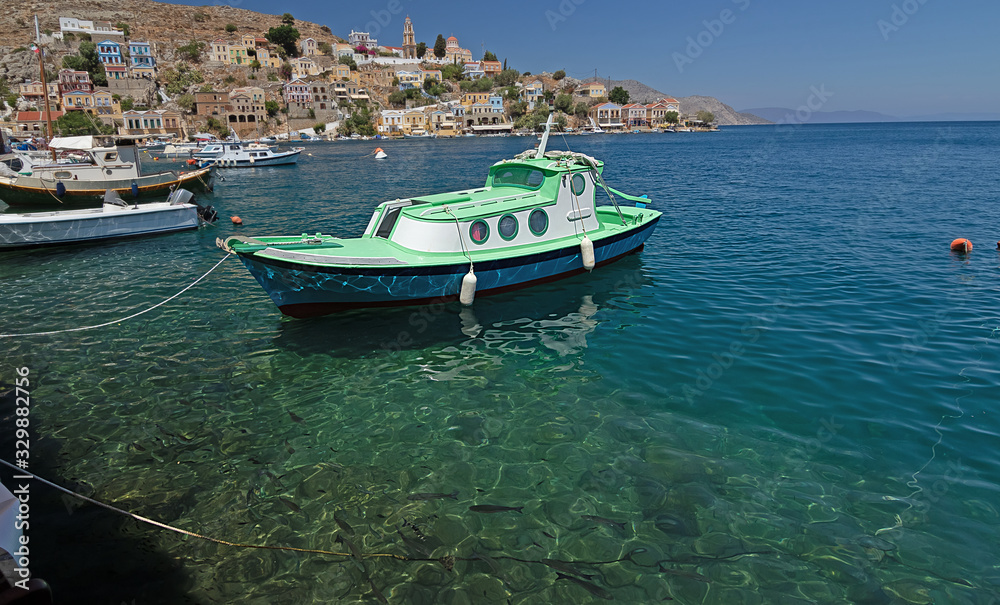 small fishing small fishing boat on the sea surface of the bay of Symi island, Greece