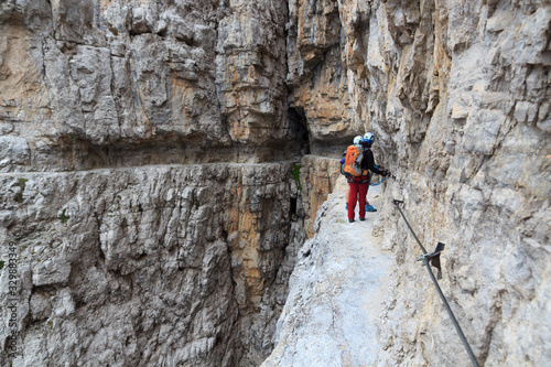 People climbing on via ferrata Sentiero delle Bocchette Centrale in Brenta Dolomites mountains, Italy