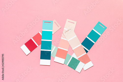 Selection of palette for painting, sample color catalog on a pink background, different shades of pink and green colors
