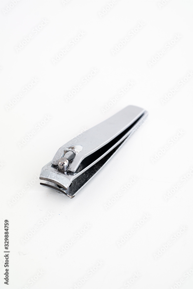 Single metal silver nail clipper macro close up shot isolated against white Single metal silver nail clipper macro close up shot isolated against white