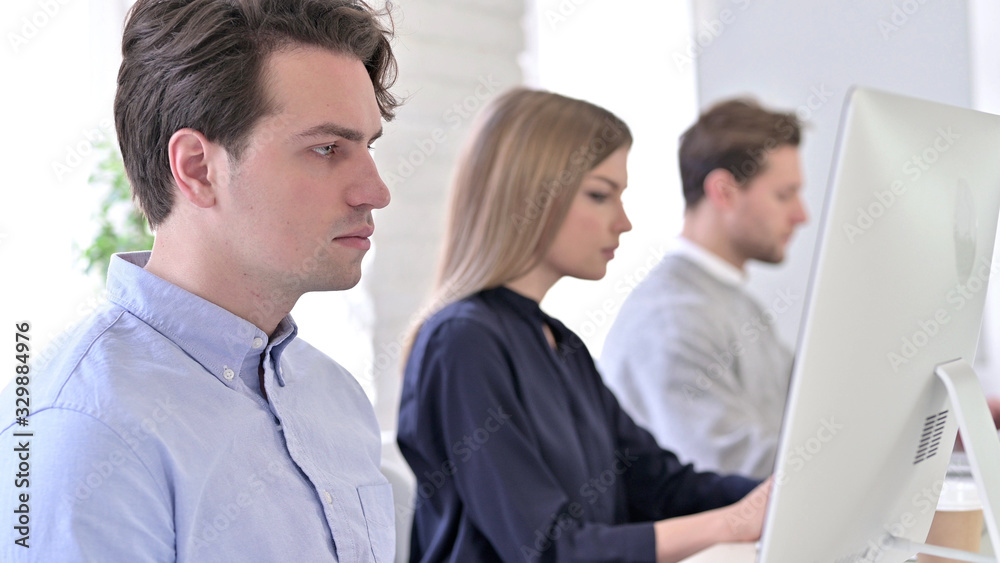 Startup Team using Desktop in Modern Office Startup Team using Desktop in Modern Office