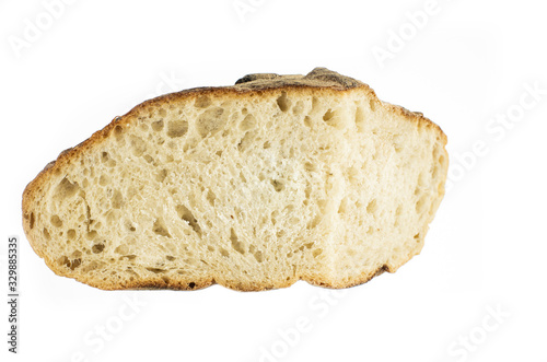 Cut piece of white grain artisan backed bread loaf close up isolated on pure white