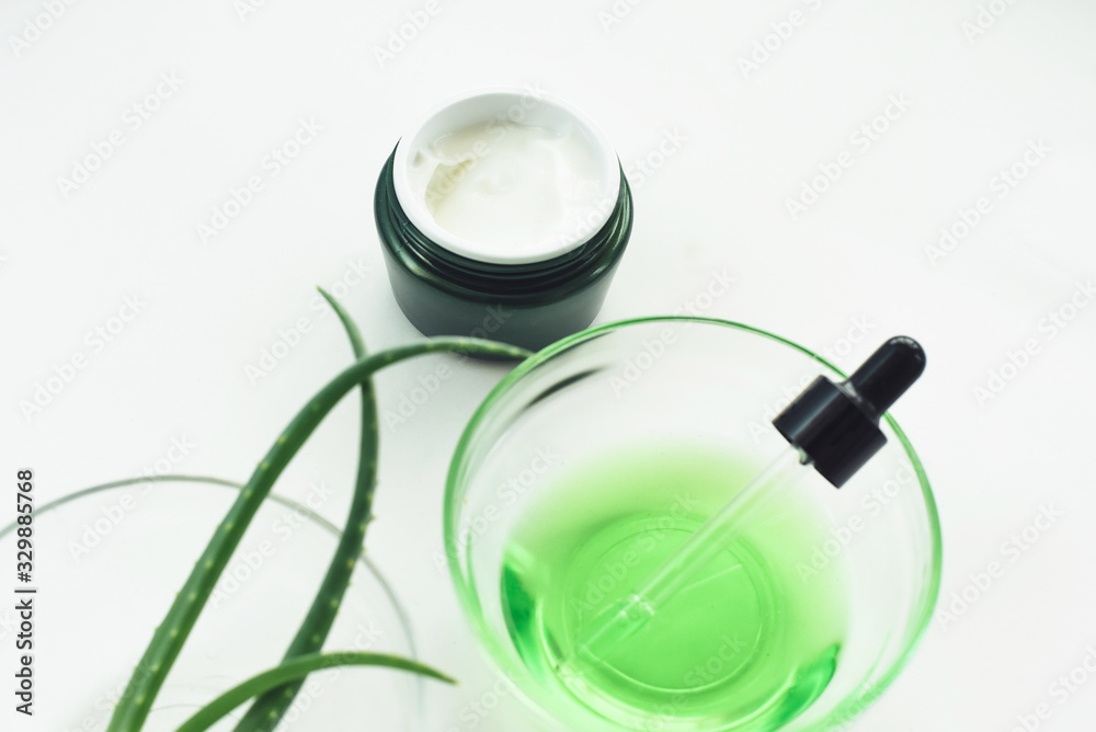 Aloe gel, aloe vera leaves, moisturizer and green serum from natural ingredients on a white background. Nursing cosmetics, skin care concept Aloe gel, aloe vera leaves, moisturizer and green serum from natural ingredients on a white background. Nursing cosmetics, skin care concept