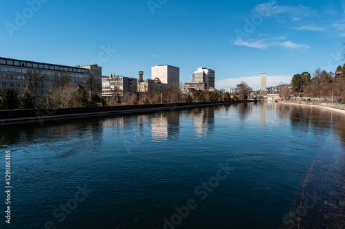 Zurich city view of the Limmat river and industrial building in the background sunny day Switzerland. © Octavian