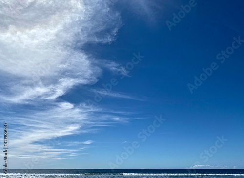 Wishpy white clouds  in a clear, blue sky © Robin Keefe