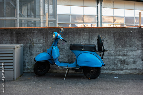 Vintage blue gas powered city scooter moped parked on the streets of Zurich Switzerland