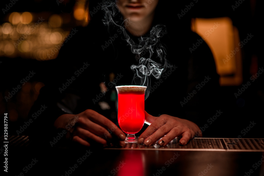 Bright red alcoholic drink standing on bar. Bright red alcoholic drink standing on bar.