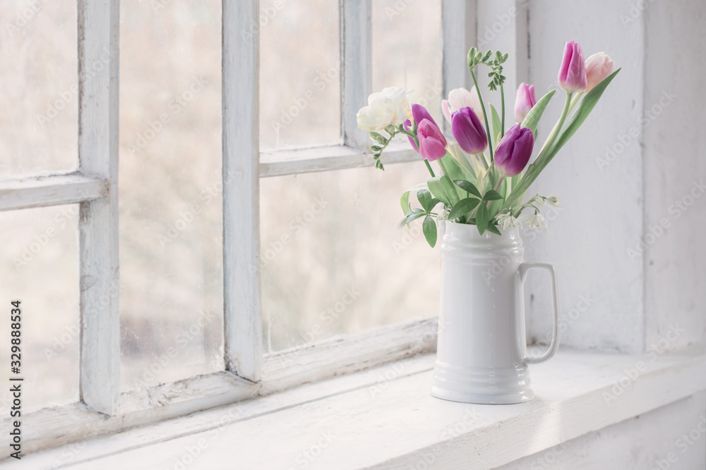 beautiful tulips on old white windowsill