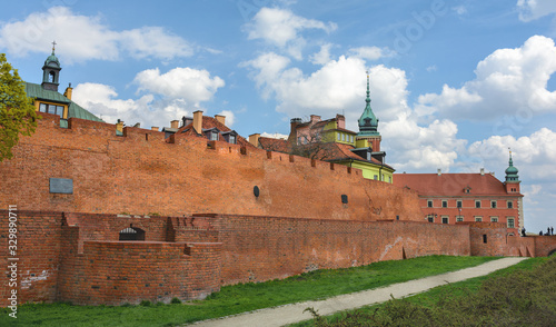 Warsaw Old city. Houses and city wall. Earthworks. Red brick city wall. Small street, Rycerska street, in the medieval old city in Warsaw. The oldest historical district of Warsaw photo