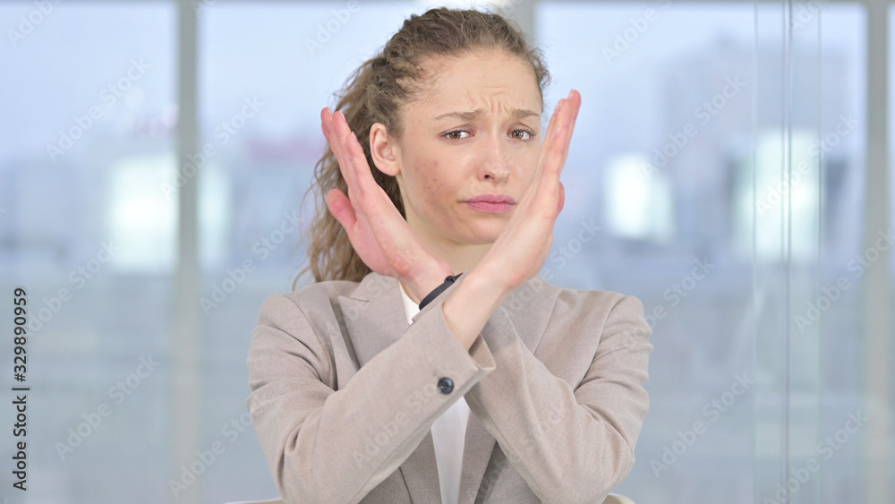 Disliking Young Businesswoman saying No by Hand Gesture