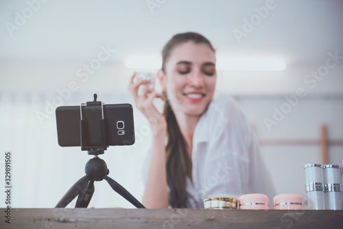 Beautiful young girl blogger is live streaming. beauty blogger talks about cosmetics. the concept of opinion leaders.