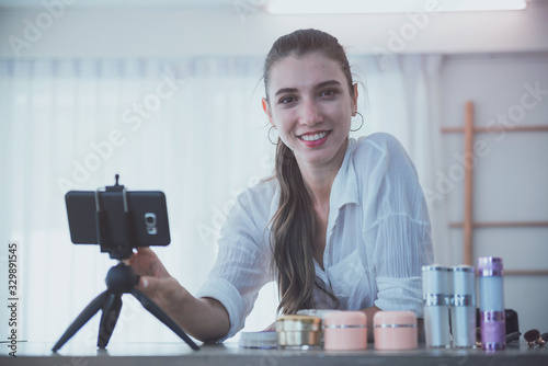 Beautiful young girl blogger is live streaming. beauty blogger talks about cosmetics. the concept of opinion leaders.