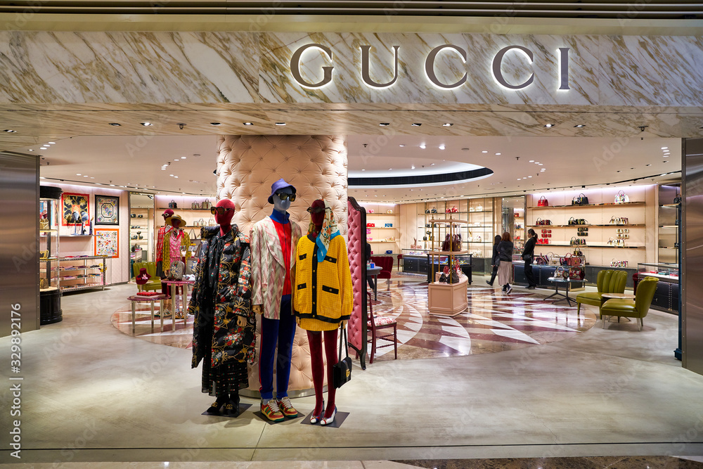 HONG KONG, CHINA - CIRCA JANUARY, 2019: Gucci brand name over shop entrance  at Elements shopping mall. Gucci is an Italian luxury brand of fashion and  leather goods. Stock Photo | Adobe Stock