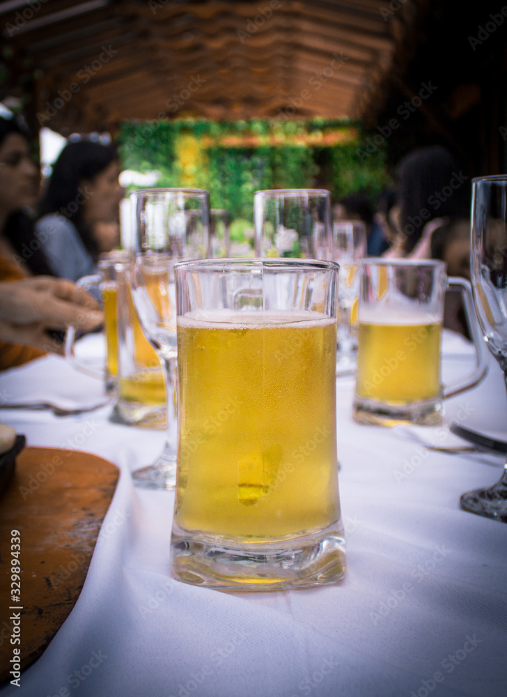 beer on white tablecloth with family
