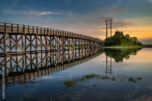 Placid sunrise next to a wooden trestle