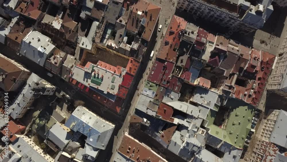Aerial view to historic and tourist center of Lviv city from above. Roofs of historic buildings and roads with tourist on it, Ukraine Aerial view to historic and tourist center of Lviv city from above. Roofs of historic buildings and roads with tourist on it, Ukraine