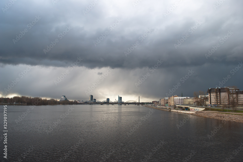 view of the city of Riga Dvina river gray storm clouds