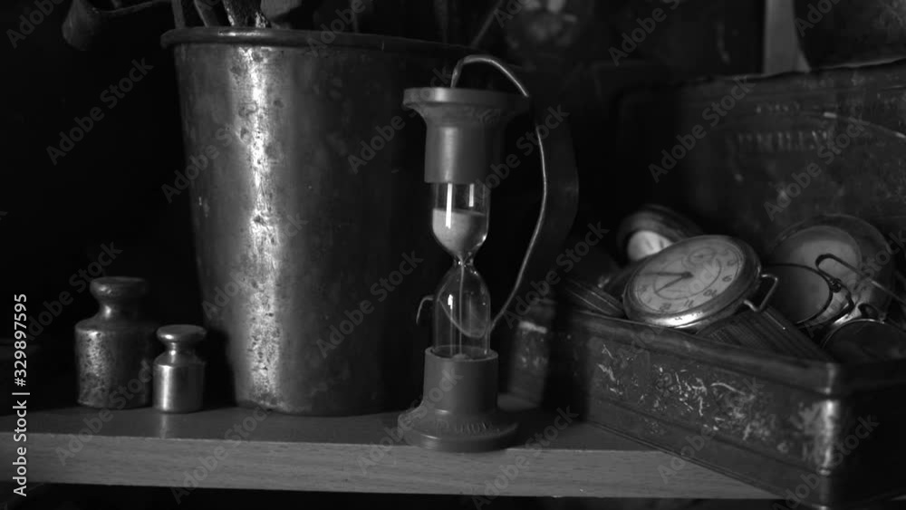 hourglass. time does not stop, the old shelf of objects