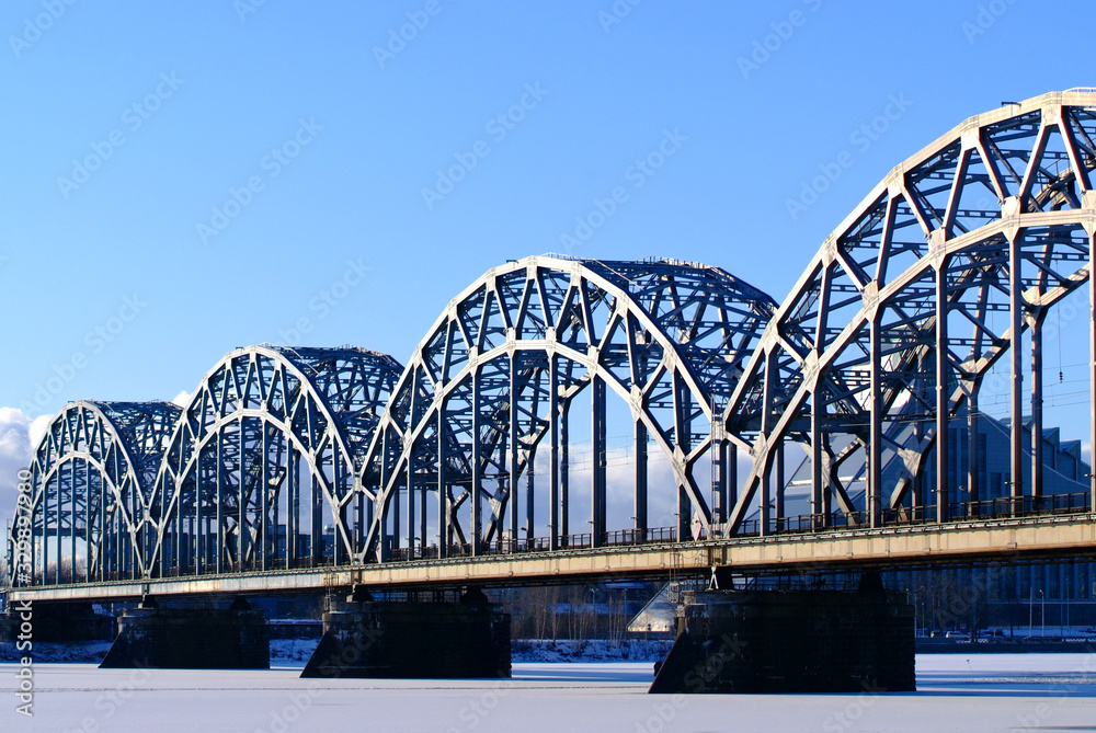 Fototapeta premium Riga city railway bridge against the blue sky