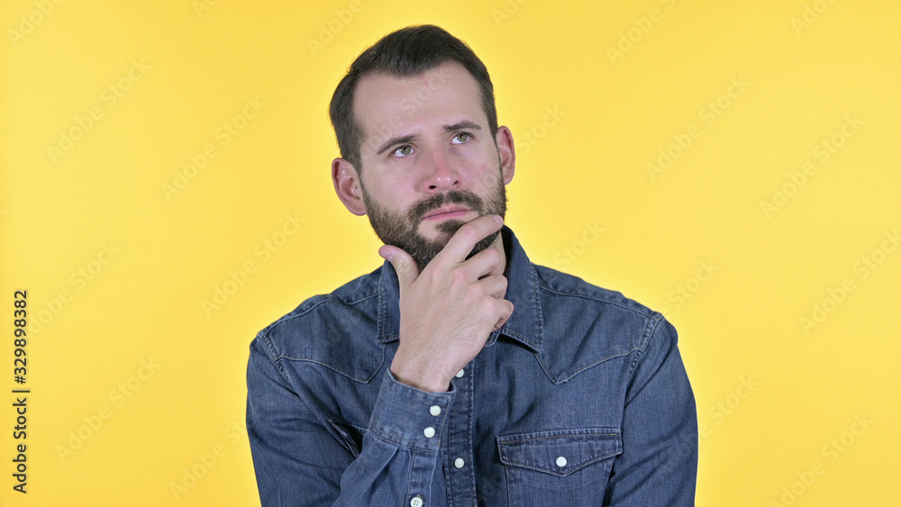 Portrait of Young Man Thinking about Idea, Yellow Background Portrait of Young Man Thinking about Idea, Yellow Background