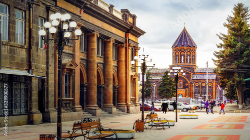 Scenic old paving street with church on the background in the historic Gyumri city in Armenia