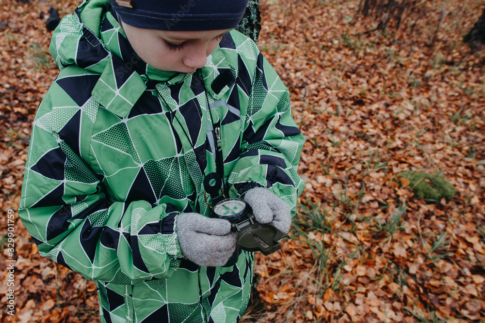 The child is guided by a compass in the woods. It's raining. Autumn. A man is lost, looking for his way home. The child is guided by a compass in the woods. It's raining. Autumn. A man is lost, looking for his way home.